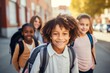 © Georgii - Group of cheerful schoolchildren hugging and looking at camera. Happy smiling multiethnic kids posing for group portrait. Children of different skin colors go to school together. Diversity concept.