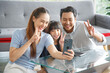 © aekkorn - Happy Asian family making heart symbol in living room while video call.  Family,love and happiness concept.
