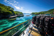 Scuba diving gear on a boat overlooking a clear turquoise sea and vibrant coastline, ready for underwater exploration.