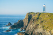 Scenic view of a landscape on the Atlantic Ocean coast with a lighthouse on top of a rocky promontory