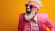 Happy elderly man in pink suit Wear sunglasses and extravagant style, Laugh and smile happily.