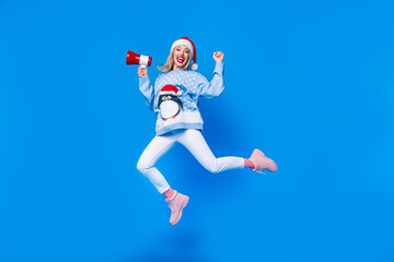 Poster - Full body cadre of jumping girl wearing ugly penguin ornament sweater hooray merry christmas proclaims isolated on blue color background