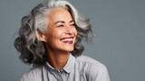 a mature lady with nice and soft skin smiling with healthy and white teeth
