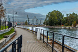 Fototapeta Paryż - A walk along the Motława River in Gdansk with a view of the shipyard.