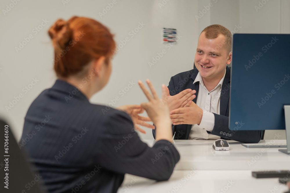 Off Task Sign Language Business partners communicate in sign language. A deaf boss gives a ...
