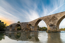The historical Aspendos Bridge over Koprucay at sunrise in Antalya Turkey