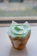 Closeup fancy cupcake, green frosting over vanilla cupcake