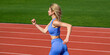 © Yevhen - Active lifestyle concept, runner. Woman in sportswear jogging on stadium. Female jogger runner running outdoors. Fitness woman on stadium. Young fitness woman runner running on stadium track