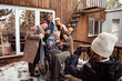 © Davor - A joyful family gathers outside their cabin for a winter photo