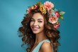 © JJAVA - Young Woman Wearing Flowers in her Hair for Spring on a Blue Background with Space for Copy