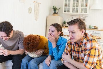 Wall Mural - Group of friends watching sport match soccer football game on tv. Happy football fans celebrating victory at home. Friendship sports entertainment concept. Diverse buddies having fun together at home