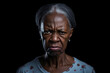 © lucky pics - Angry senior African American woman, head and shoulders portrait on black background. Neural network generated image. Not based on any actual person or scene.
