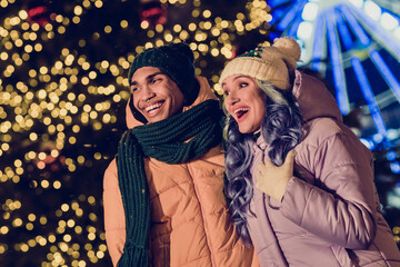 Canvas Print - Photo of positive excited american guy lady wear windbreakers watching xmas miracle together outside urban ferris wheel market park