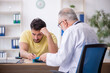© Elnur - Young male patient visiting old male doctor