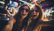 Happy girls friends having fun and dancing in a disco bar. Nightlife of active youth. Party and entertainment concept