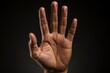 © Deivison - Open hand making stop gesture, black background. Generative AI
