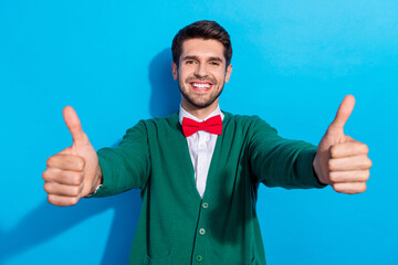 Sticker - Photo of charming confident guy dressed xmas green cardigan rising two thumbs up isolated blue color background