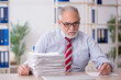 © Elnur - Old male employee and too much work in the office