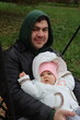 © Владислав Порхун - dad holds a little girl in his arms and rides on a swing in the park in autumn