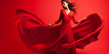 woman in long red dress dancing on red background