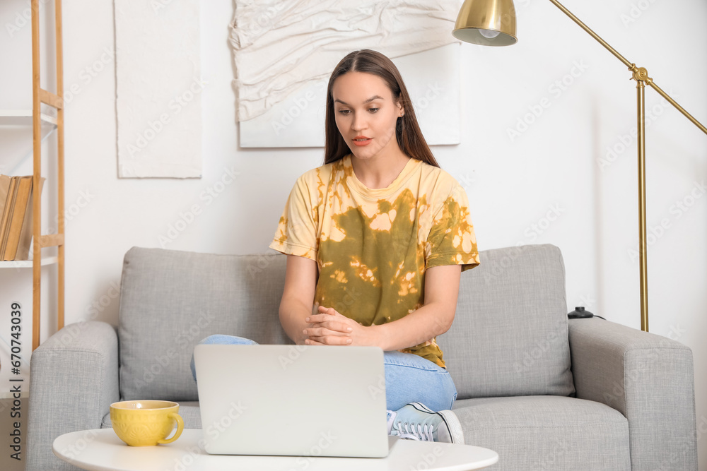 Young woman video chatting with doctor at home