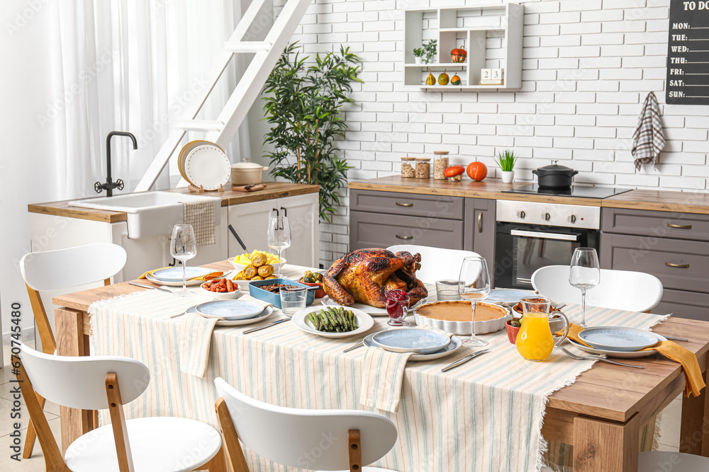 Festive dining table with tasty food for Thanksgiving Day in kitchen