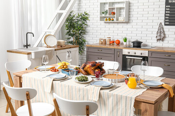 Poster - Festive dining table with tasty food for Thanksgiving Day in kitchen