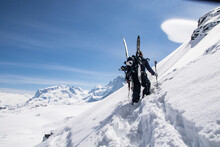 Unrecognizable Person Climbing Snowcapped Mountain