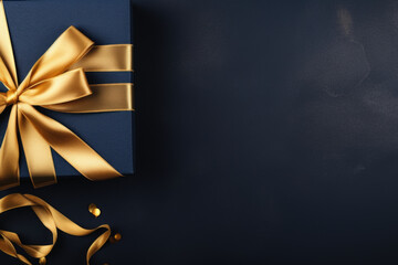 Wall Mural - A blue gift box with a gold ribbon, perfect for any special occasion or celebration