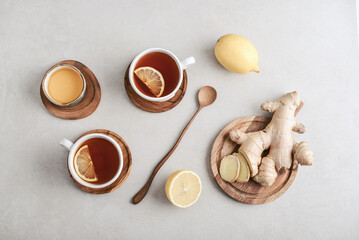 Wall Mural - Tea  in a white cups with lemon, ginger root