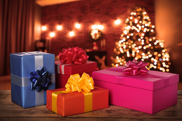 Poster - Gift boxes on wooden table in room decorated for Christmas