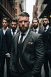 © piai - Handsome tattooed gangster man, with a beard in a luxurious suit, standing with a group of brothers