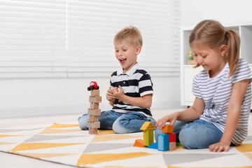 Poster - Little children playing with building blocks indoors, space for text. Wooden toys