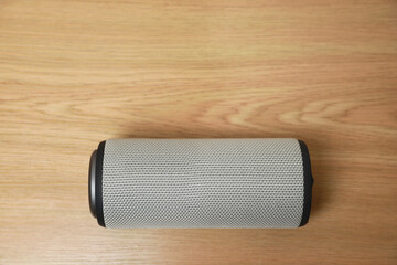 Wall Mural - One portable bluetooth speaker on wooden table, top view with space for text. Audio equipment