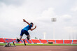 © Kawee - Asian athletes are disabled with prosthetic blades running at stadium.