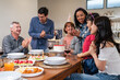 © Kawee - Multi-ethnic big family having birthday party for senior grandmother.