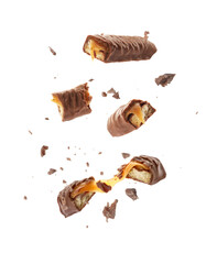 Poster - Pieces of chocolate bars with caramel falling on white background