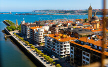 View Of Colorful Summer Cityscape Of Getxo From Vizcaya Bridge With Neighborhood Of Las Arenas In Foreground, Spain..