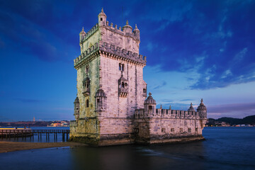 Wall Mural - Belem Tower or Tower of St Vincent - famous tourist landmark of Lisboa and tourism attraction - on the bank of the Tagus River (Tejo) after sunset in dusk twilight with dramatic sky. Lisbon, Portugal