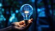 © Putra - Hand holds a lightbulb, illuminating the path to innovation