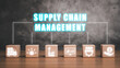 Supply chain management concept, Wooden blok on desk with supply chain management icon on virtual screen.