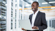 © ImageFlow - Data Center Engineer with Laptop Computer. Portrait of African American System Administrator. Server Room Specialist, Cyber Security Concept. Data Protection Network, Ai Generative