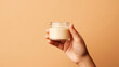 Close up of hand holding a jar of cosmetics product. Skincare hygiene moisturiser