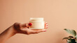 Close up of hand holding a jar of cosmetics product. Skincare hygiene moisturiser