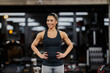 © dusanpetkovic1 - Portrait of a happy muscular sportswoman confidently standing in a gym.
