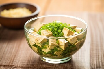 Wall Mural - raw tofu in an asian-inspired marinade in a glass bowl