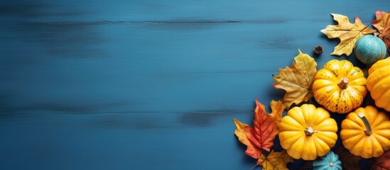 Poster - Fall themed table with yellow leaves pumpkins and space for text