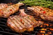 shiny grill grate with sizzling veal chops and herbs