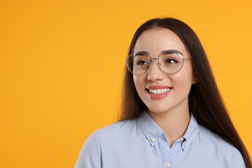 Sticker - Beautiful woman wearing glasses on orange background, space for text