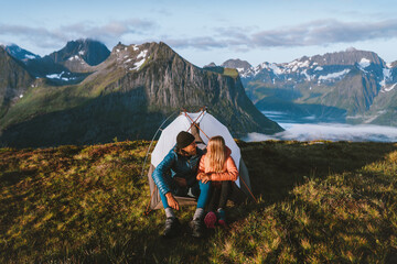 Wall Mural - couple friends traveling together with camping tent gear romantic vacations man and woman hiking adv